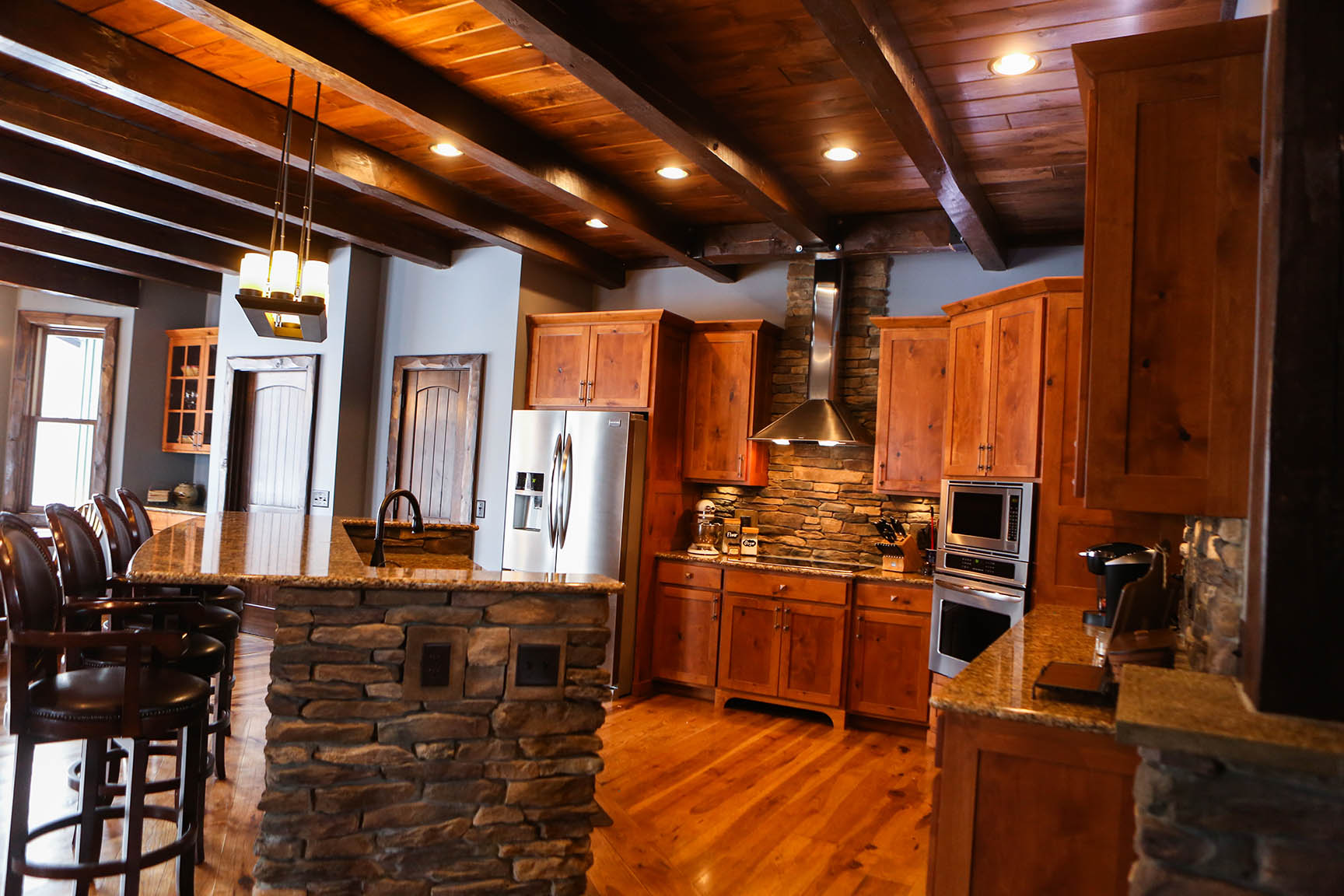 In today’s rustic kitchens hewed trims, stone, and timbers help create a warm feeling. With our different accents we can help create your modern rustic design.
