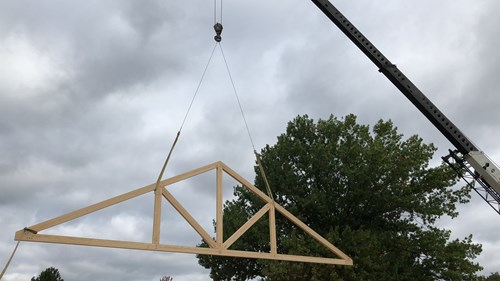 Queen post truss installation. Timber truss manufacturers