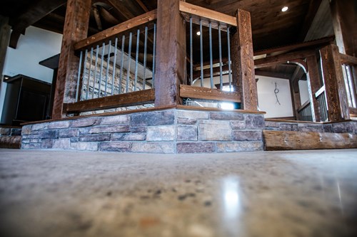 Circle-sawn rebar rustic railing in wedding barn.