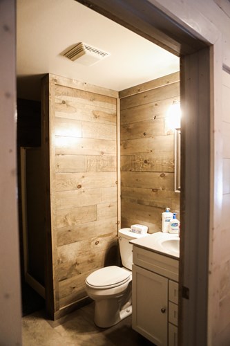 Bathroom with 8” shiplap walls in weathered grey.
