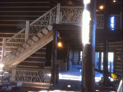 Twig railing on a log staircase. rustic railing