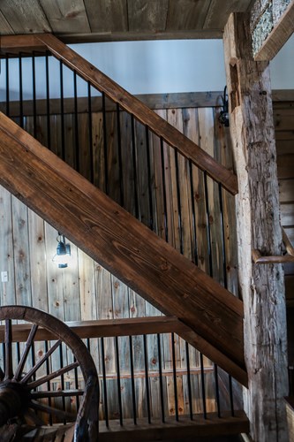 Staircase with black bar rustic railing.