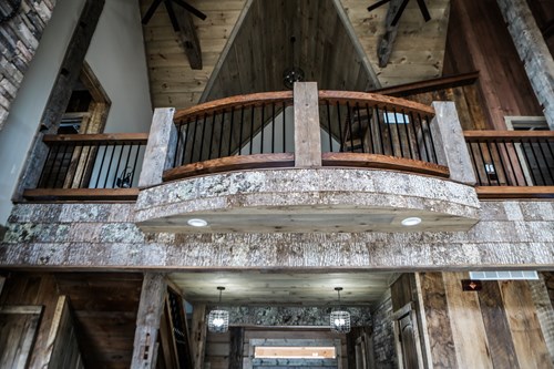 Balcony deck with black bar rustic railing.