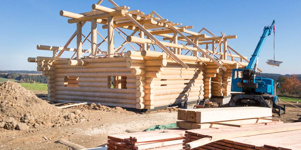 Construction workers building a log cabin home