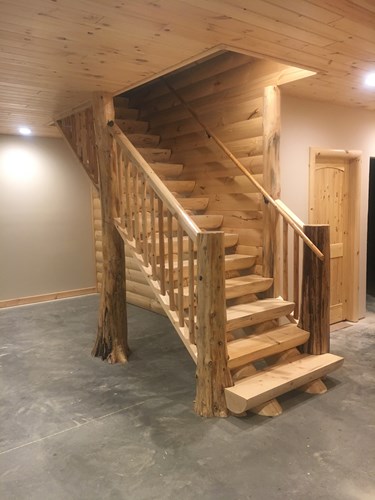 Milled half log staircase with flare bottom trees.