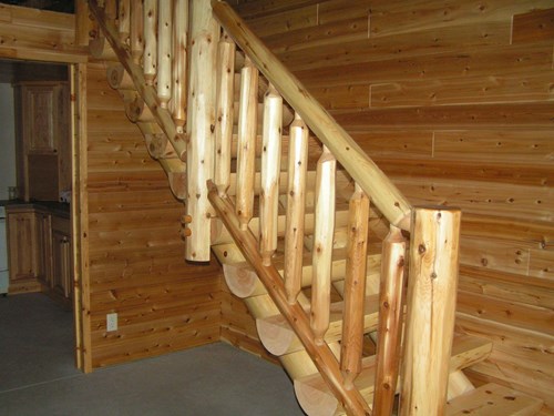 Milled half log staircase with traditional cedar log railing.