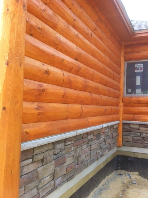 4x10 white pine Paul Bunyon siding stained with our Storm cedar.