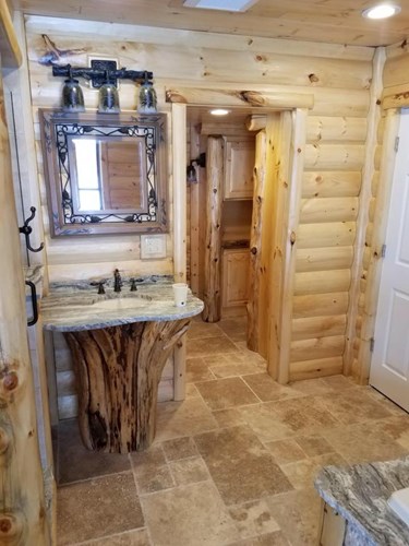 3x8-hand-hewn-pine-log-siding_pre-finished_flare-bottom-trees-1