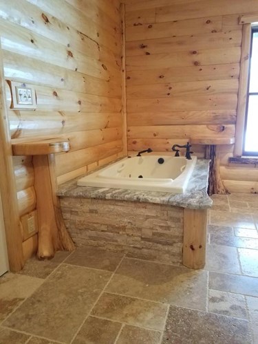 3x8-hand-hewn-pine-log-siding_pre-finished_flare-bottom-trees-2